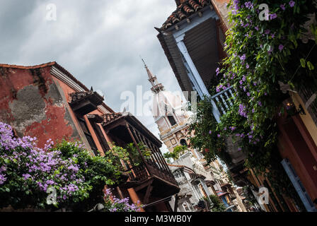 A photo of old buildings with wooden balconies covered in flowers in the historic center of Cartagena, Colombia Stock Photo