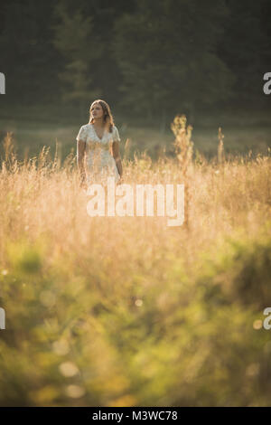 High school senior girl portraits outside during summertime. One person. Beautiful brunette teenage female. Stock Photo