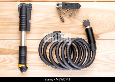 pump, lock and a set of tools for a bicycle on wooden boards top view Stock Photo