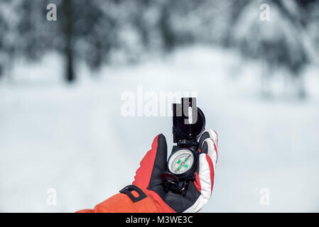 hand of a tourist in a glove close-up with a compass Stock Photo