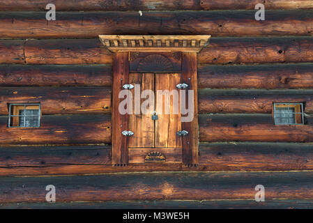 A locked wooden shutters on the wooden wall. Stock Photo