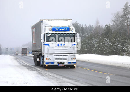 RAASEPORI, FINLAND - FEBRUARY 9, 2018: Beautifully customized DAF XF 105 truck of J Kurki hauls Freja cargo trailer along highway in winter. Stock Photo