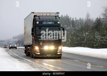 RAASEPORI, FINLAND - FEBRUARY 9, 2018: Beautifully customized Volvo FH truck of SCS for Posti Group transports lights up the wintery highway in South  Stock Photo