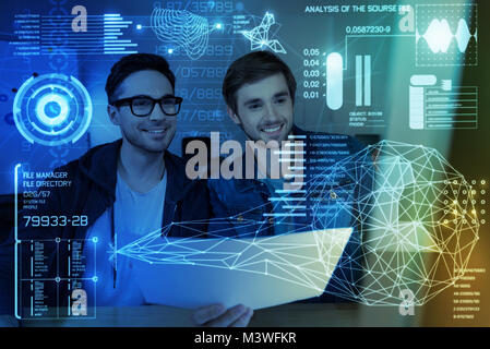 Cheerful programmers working together Stock Photo