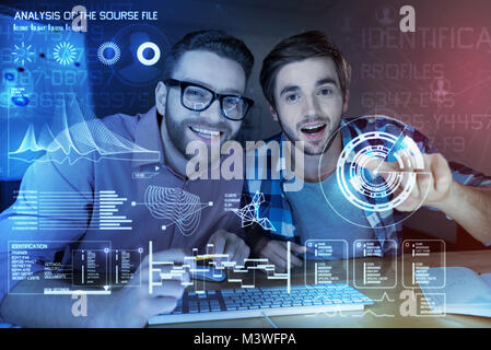 Positive programmer developing a new security programm Stock Photo