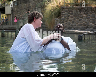 170702-N-FE442-269  JORDAN RIVER, Israel (July 2, 2017) Lt. Cmdr. Margaret Siemer, a Navy chaplain assigned to the aircraft carrier USS George H.W. Bush (CVN 77), baptizes a Sailor in the Jordan River during a port visit to Israel. The ship is in Haifa, Israel for a scheduled port visit to enhance U.S.-Israel relations. (U.S. Navy photo by Mass Communication Specialist 3rd Class Matt Matlage/Released) 170702-N-FE442-269 by Photograph Curator Stock Photo