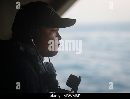 STRAIT OF HORMUZ (July 23, 2017) U.S. Navy Aviation Ordnanceman 3rd Class John Guinto, from Mabalaccat, Pampanga, Philipphines, stands a full-bore watch aboard the aircraft carrier USS Nimitz (CVN 68), July 23, 2017, in the Strait of Hormuz. Nimitz is deployed in the U.S. 5th Fleet area of operations in support of Operation Inherent Resolve. While in this region, the ship and strike group are conducting maritime security operations to reassure allies and partners, preserve freedom of navigation, and maintain the free flow of commerce. (U.S. Navy photo by Mass Communication Specialist 3rd Class Stock Photo