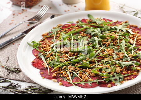 beets with peanuts on white wooden background, breakfast Stock Photo