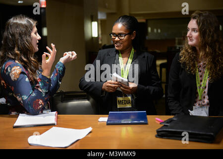 Following successful high level interview sessions, Defense Media Activity (DMA) Social Media Specialist, Alexandra Snyder (left) critiques and mentors Department of Defense Education Activity (DODEA) Cub Reporters, Mary Elizabeth Ingram (center) and Lauren Lemon (right), both Seniors from Quantico Middle/High School at Marine Corps Base Quantico, Virginia, after interviewing Military leadership during the Military Child Education Coalition (MCEC) 19th Annual National Training Seminar at the Renaissance Washington, DC Downtown Hotel.  DMA Social Media personnel mentored the students throughout Stock Photo