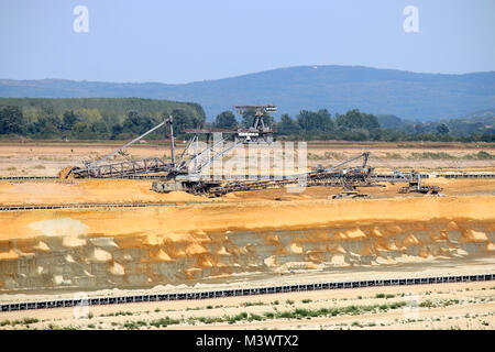 Giant excavator digging coal on open pit coal mine Stock Photo