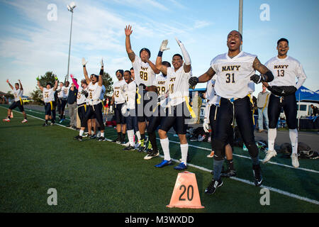 171208-N-EH218-0171 OAK HARBOR, Wash. (Dec. 8, 2017) Sailors celebrate a touchdown during the 18th annual Army/Navy flag football game between Navy Region Northwest and Joint Base Lewis-McChord held at Costen Turner Field. The game was held ahead of the college football rivalry game between U.S. Naval Academy, Navy Midshipmen, and U.S. Military Academy, Army Black Knights. (U.S. Navy photo by Mass Communication Specialist 2nd Class Ryan J. Batchelder/Released) 171208-N-EH218-0171 by Naval Base Kitsap (NBK) Stock Photo