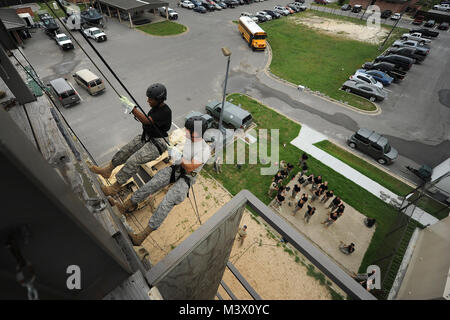 From right, retired Col. Ken Rodriguez repels down a tower with Cadet Marlene Burgess at Hurlburt Field, Fla. (U.S. Air Force photo/Staff Sgt. David Salanitri) JROTC010 by AirmanMagazine Stock Photo