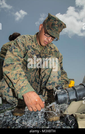 Lance Cpl. Esgar Castro, a water support technician assigned to 8th Engineer Support Battalion, tests chlorine levels in the water his team is providing for U.S. service members in Guatemala. The Marines are in Guatemala working with the Guatemalan military as part of Southern Partnership Station 2014. Southern Partnership Station 2014 is a U.S. Navy and Marine Corps deployment focused on subject matter expert exchanges with partner nation militaries and security forces in Central and South America and the Caribbean.  U.S. military teams work with partner nation forces during naval maritime-fo Stock Photo