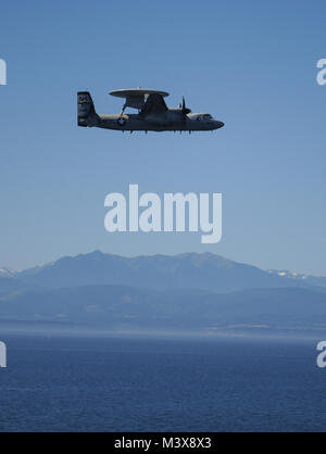 PUGET SOUND, Wash. (July 31, 2014) An E-2C Hawkeye assigned to the Wallbangers of Airborne Early Warning Squadron (VAW) 117 flies over the aircraft carrier USS Nimitz (CVN 68) during a friends and family day cruise airshow. Nimitz returned to Naval Station Everett after hosting more than 400 friends and family members during a one-day cruise. (U.S. Navy photo by Mass Communication Specialist 3rd Class Kelly M. Agee/Released) 140731-N-AZ866-090.jpg by USS NIMITZ (CVN 68) Stock Photo