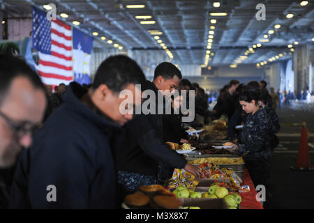 PUGET SOUND, Wash. (July 31, 2014) Sailors dish up food in the hangar bay of the aircraft carrier USS Nimitz (CVN 68) during a Friends and Family Day Cruise. Nimitz returned to Naval Station Everett after hosting more than 400 friends and family members during a one-day cruise. (U.S. Navy photo by Mass Communication Specialist 3rd Class Eric M. Butler/Released) 140731-N-UV347-127.JPG by USS NIMITZ (CVN 68) Stock Photo