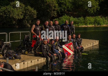 Wounded Warriors takes a group photo before starting a scuba diving class at Spring Lake in San Marcos, Texas. The Center for the Intrepid provides rehabilitation for Operation Iraqi Freedom and Operation Enduring Freedom casualties who have sustained amputation, burns, or functional limb loss, and provides education to DoD and Department of Veteran's Affairs professionals on cutting edge rehabilitation modalities, and to promote research in the fields of Orthopedics, prosthetics, physical and occupational rehabilitation. (U.S. Air Force photo/Senior Airman Cory Payne) 140807-F-WJ663-109 by Ai Stock Photo