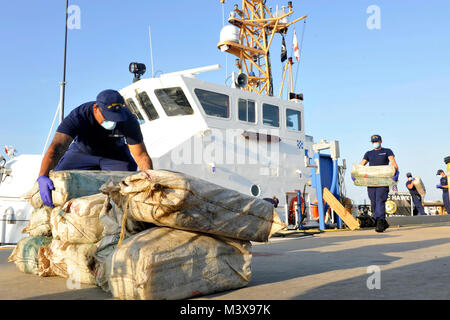 Crew members from U.S. Coast Guard Cutter Hawk, an 87-foot patrol boat homeported in St. Petersburg, Fla., offloads 576 kilograms of cocaine, valued at $19 million at Coast Guard Sector St. Petersburg, Friday, Aug. 22, 2014. The contraband was interdicted during Operation Martillo, a joint interagency and multi-national collaborative effort among 14 Western Hemisphere and European nations to stop the flow of illicit cargo by Transnational Criminal Organizations. (U.S. Coast Guard photo by Seaman Meredith Manning) 140822-G-EP136-001 by ussouthcom Stock Photo