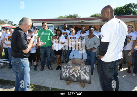 Miami Heat President Pat Riley and Miami Heat veteran Alonzo Mourning speak to military members during a Commitment to Service home rebuild Nov. 11, 2014. Service members from the Coast Guard and United States Southern Command alongside the Miami Heat and Rebuilding Together Miami-Dade, came together to rebuild the homes of two veterans on Veterans Day. (Coast Guard photo by Petty Officer 3rd Class Jon-Paul Rios) 141111-G-KZ985-999 by ussouthcom Stock Photo