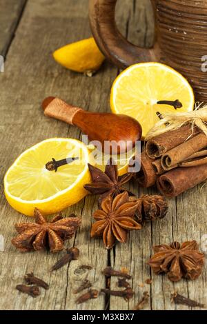 Dried herbs and seasoning. Star of anise, cinnamon sticks and cloves lying on wooden table, seasoning for cooking and baking Stock Photo