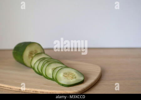 Sliced Cucumbers on a Wood Cutting Board Stock Photo