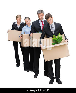 Unhappy Businesspeople Standing With Their Belongings In Cardboard Box Isolated On White Background Stock Photo