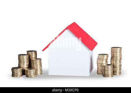 Close-up Of House Model And Stacked Coins On White Background Stock Photo