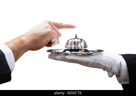 Customer's Hand Ringing Service Bell Held By Waiter On White Background Stock Photo