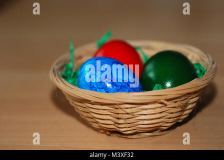 colorfully painted Easter eggs in three straw basket Stock Photo