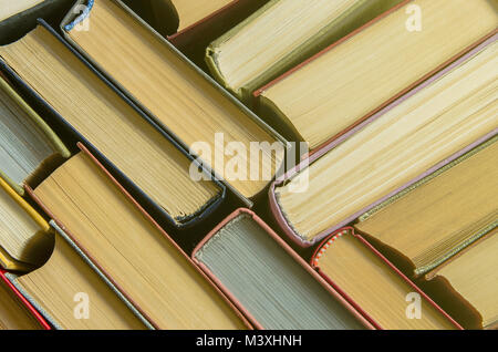 Many old books, top view, like background. The concept of education. A stack of colorful books in a library or a room Stock Photo