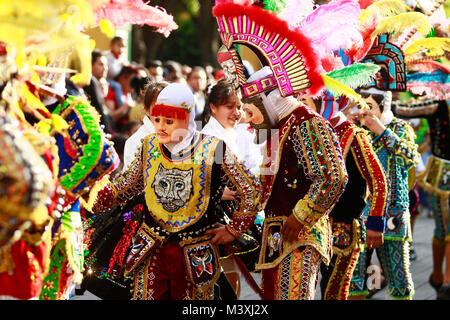 TLAXCALA, MEXICO - FEBRUARY, 08, 2018 Group of mexican dancers with bright mexican folk costumes during the annual parade to celebrate the beginning o Stock Photo
