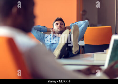 Smiling young man using digital tablet in the office Stock Photo