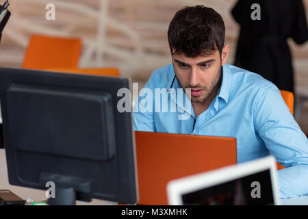 Closeup of Shocked Young Man Working on Laptop Stock Photo