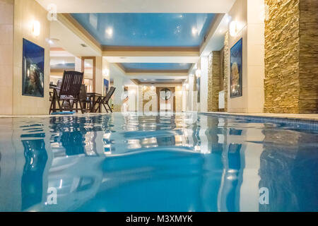 Indoor swimming pool in hotel spa center. Spa and Wellness centre with swimming pool, bath, sauna, and restaurant inside Stock Photo
