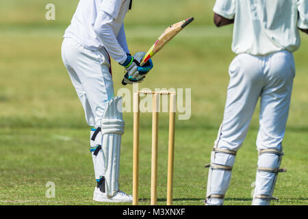 Cricket game action closeup unidentified abstract bowler batsman wicket keeper. Stock Photo