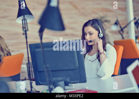 Woman working at computer in an office Stock Photo