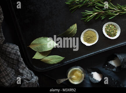 Food spices and seasonings on a black pan Stock Photo