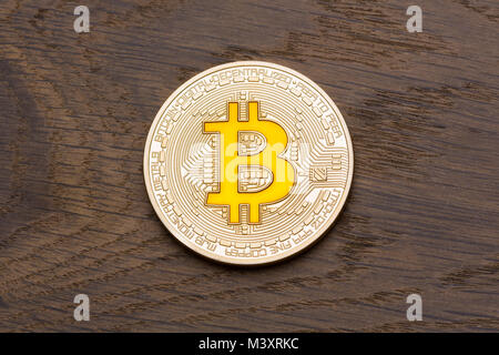 Brown background with golden cryptocurrency yellow bitcoin on it Stock Photo