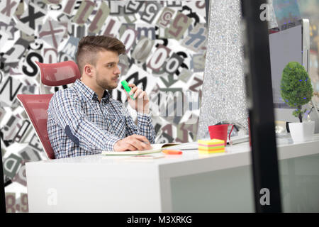Handsome young man working with laptop in office Stock Photo