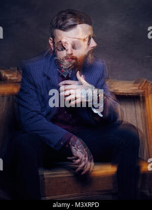 Bearded man with tattooes on his arms. Stock Photo