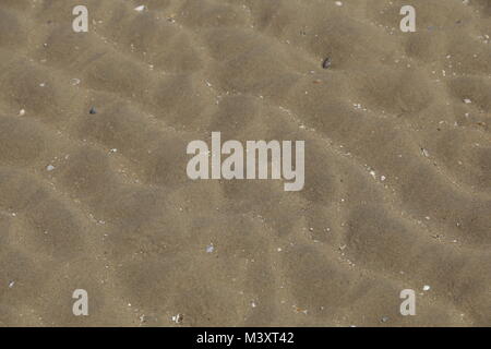 Patterns in the sand, made by the sea Stock Photo
