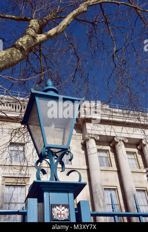 an old blue painted traditional antique streetlight or lamp lantern in the centre of the capital city of london in front of a large historic georgian Stock Photo