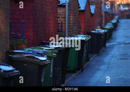 Back alley full of wheelie bins Stock Photo