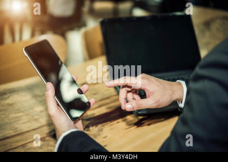 Business connection technology concept, hand of businessman using smartphone to connect to people, checking email. Stock Photo
