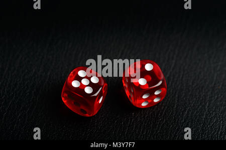 Two dice counting seven on a black leather Stock Photo