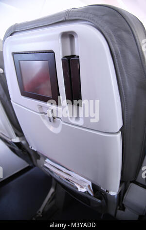 Details of old seats blank screen monitor on the plane Stock Photo