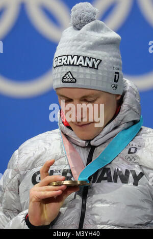 Pyeongchang, South Korea. 13th Feb, 2018. German biathlete Benedikt Doll celebrates his bronze medal at the Winter Olympics in Pyeongchang, South Korea, 13 February 2018. Credit: Michael Kappeler/dpa/Alamy Live News Stock Photo