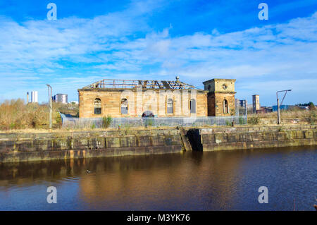 Glasgow, Scotland, UK. 13th February, 2018. UK Weather. Sunshine in Glasgow at the Pump House in Govan Graving Docks which were built between 1869 and 1898 using cut basalt rock and have been granted A-Listed building status. Credit: Skully/Alamy Live News Stock Photo