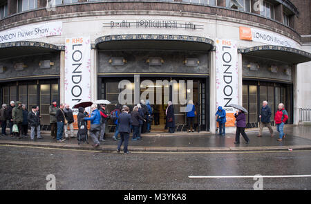 RHS Halls, Westminster, London, UK. 13 February, 2018. The Early Spring Plant Fair opens to celebrate the start of a new growing season, with visitors queueing in heavy rain. Credit: Malcolm Park/Alamy Live News. Stock Photo