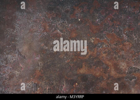 Abstract rusty grunge background, sheet of iron with red and brown alternating stains. Stock Photo