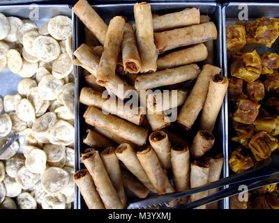 Photo of assorted snack food items sold at a street food kiosk Stock Photo